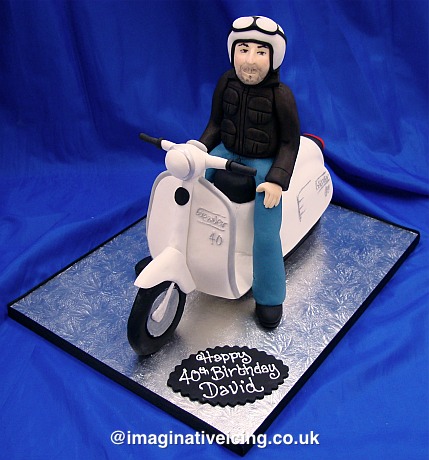 Man riding a white Scooter/Lambretta/Vespa shaped Birthday Cake
