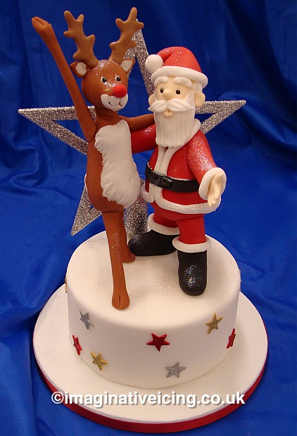 Rudolf the red nosed Reindeer & Father Christmas dancing on a Star covered Christmas cake