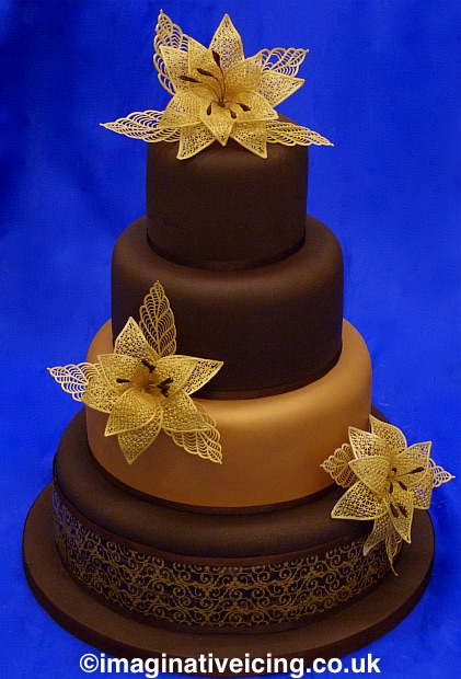 chocolate wedding cake with edible gold lace flowers