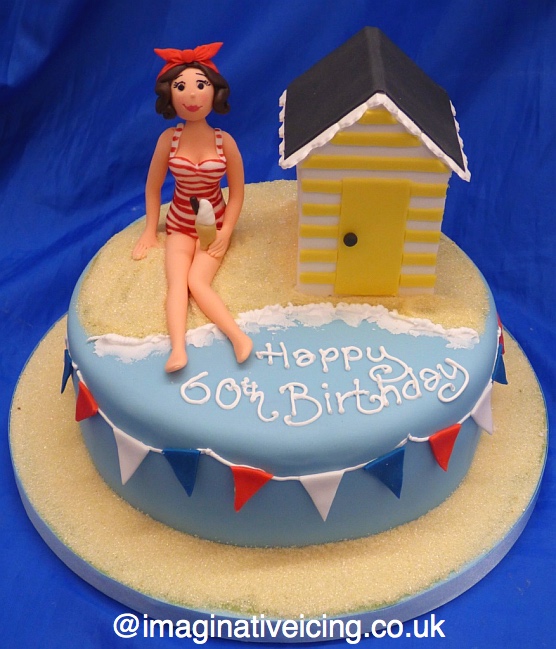 beach chalet cake with lady wearing vintage swimming costume / swimwear